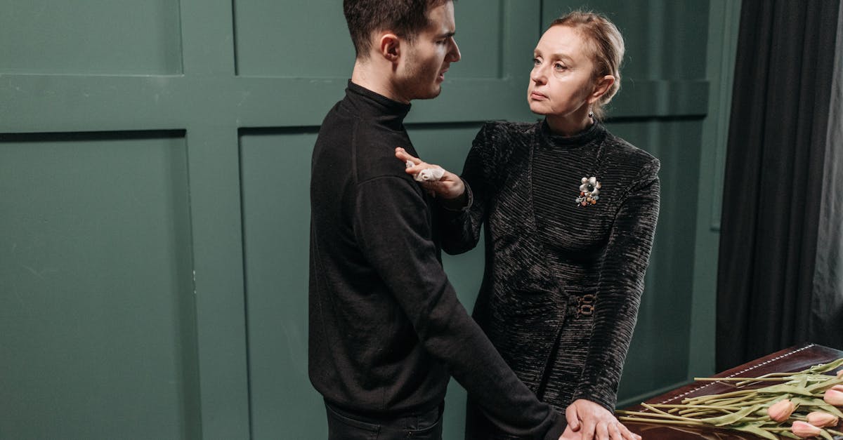 An Elderly Woman Comforting a Young Man